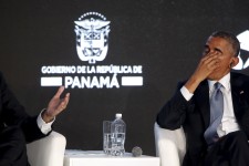 Obama rubs his eyes as he listens to his fellow speakers deliver remarks to business leaders at the CEO Summit of the Americas in Panama City, Panama