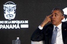 Obama rubs his eyes as he listens to his fellow speakers deliver remarks to business leaders at the CEO Summit of the Americas in Panama City, Panama
