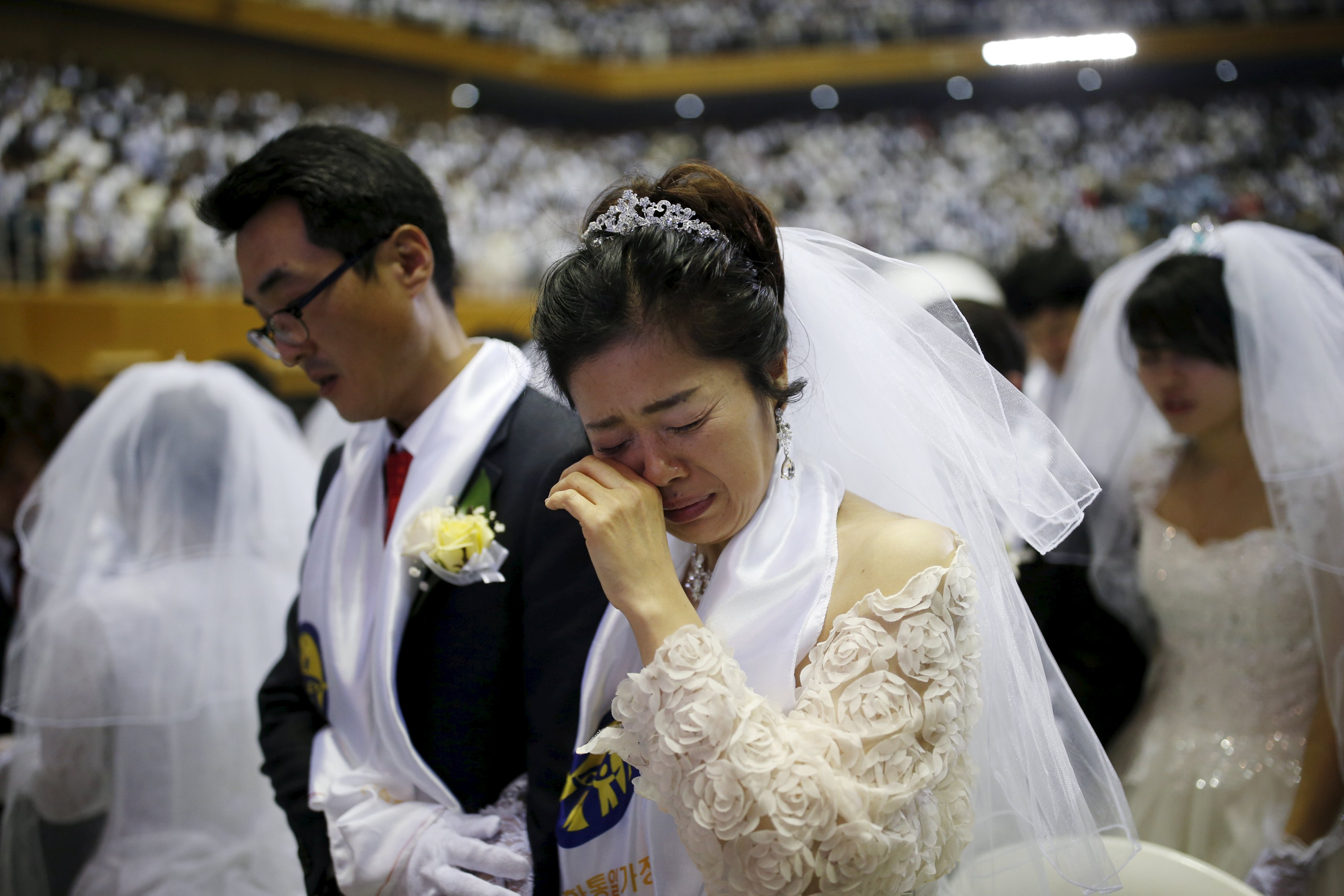 A bride cries during a mass wedding ceremony of the Unification Church at Cheongshim Peace World Centre in Gapyeong, South Korea, February 20, 2016. REUTERS/Kim Hong-Ji SOUTH KOREA-MASS WEDDING/