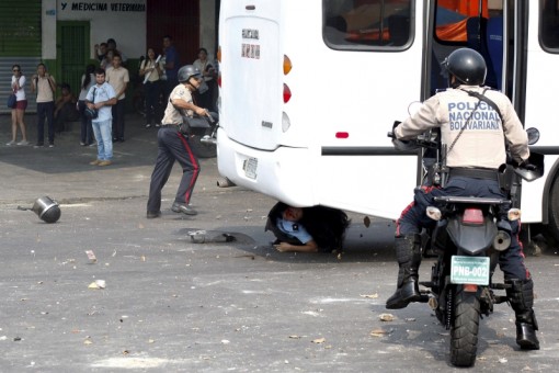 A police officer is run over by a bus during a protest against the increase in the price of public transport in San Cristobal