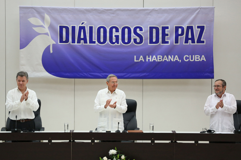 Cuba's President Raul Castro (C), Colombia's President Juan Manuel Santos (L) and FARC rebel leader Rodrigo Londono, better known by the nom de guerre Timochenko, react during the beginning of the ceremony to sign a historic ceasefire deal in Havana, Cuba, June 23, 2016. REUTERS/Alexandre Meneghini