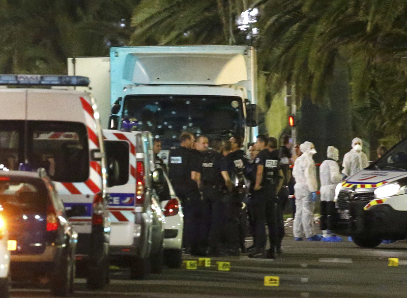 French police forces and forensic officers stand next to a truck July 15, 2016 that ran into a crowd celebrating the Bastille Day national holiday on the Promenade des Anglais killing at least 60 people in Nice, France, July 14.   REUTERS/Eric Gaillard